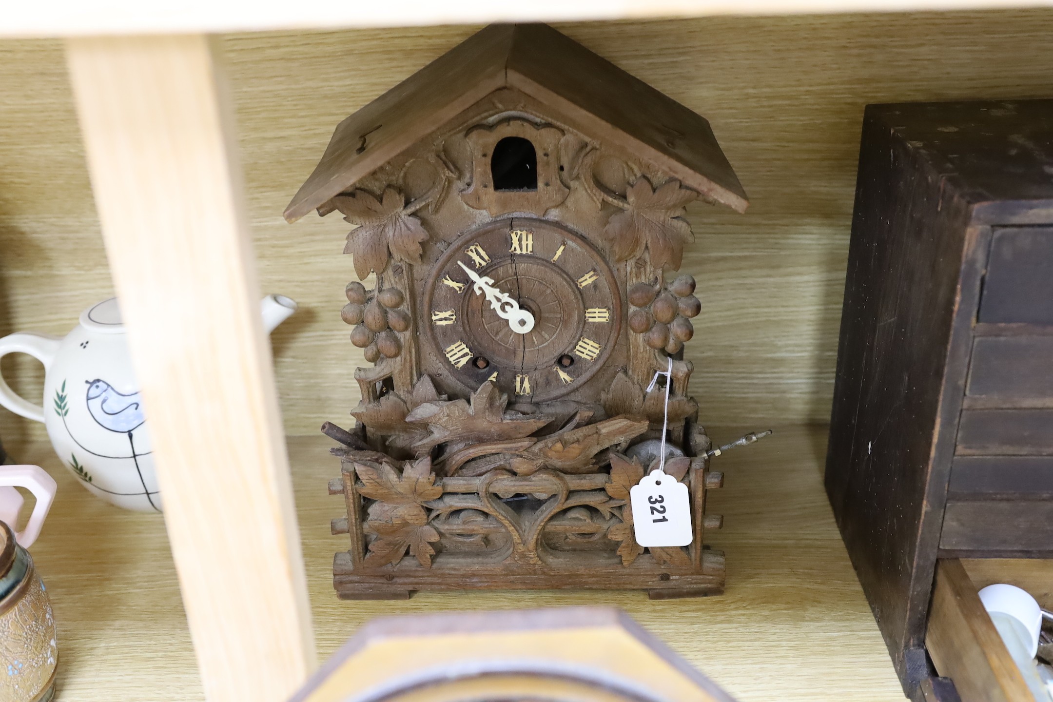 A Black Forest cuckoo clock, together with another octagonal faced timepiece, a Bakelite timepiece and another (4)